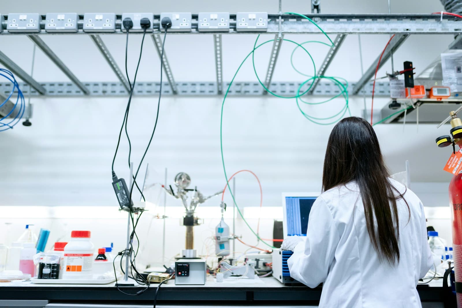 A scientist working on a laptop at a laboratory bench